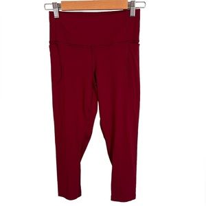 NWOT Under Armor capri leggings. Maroon/red SZ S